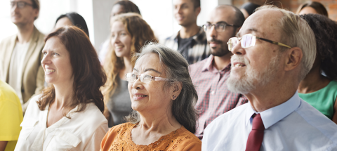 Image of a group of happy people in a meeting setting
