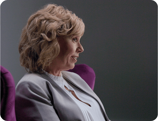 Image of a woman sitting in a purple chair for Episode 2 – Finding a Path Forward 